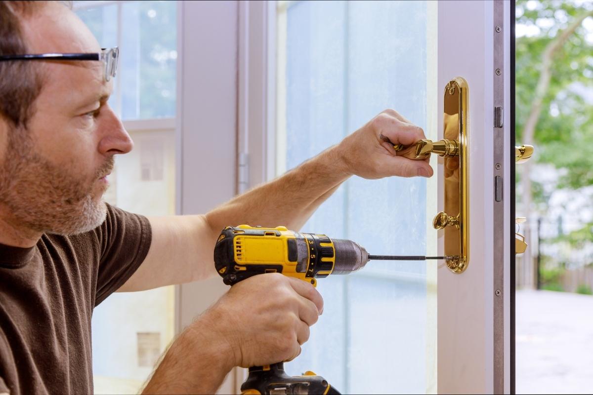 Professional locksmith fixing broken door lock