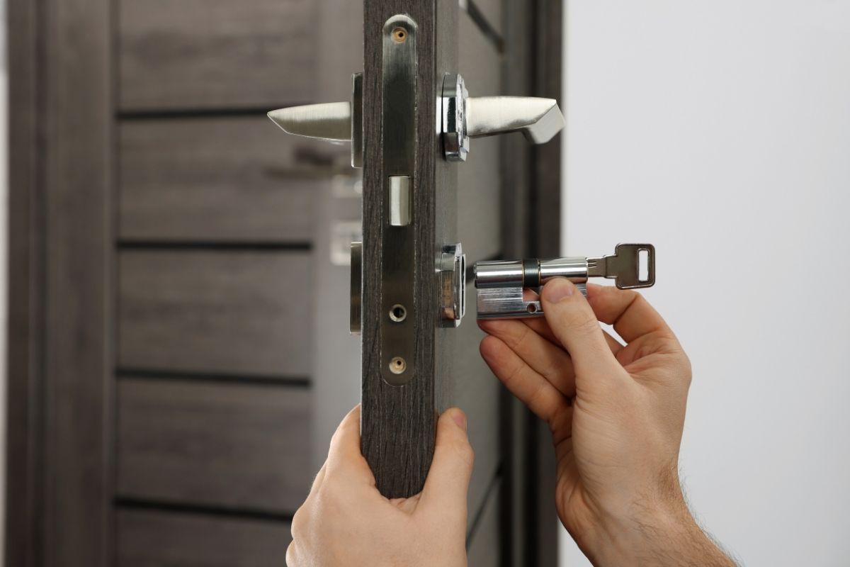 Skilled locksmith installing new door lock