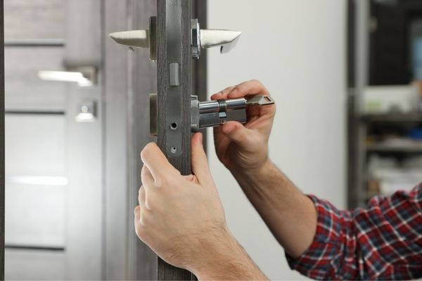Locksmith repairing front house entry lock