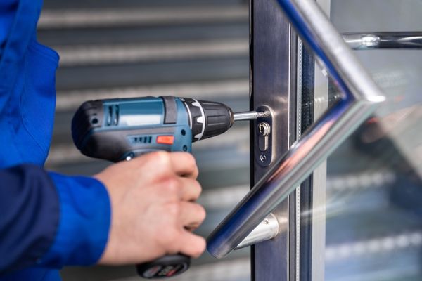 Technician performing commercial lock installation service