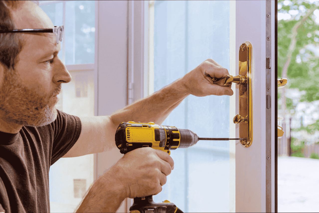 Locksmith using screwdriver to fix the lock