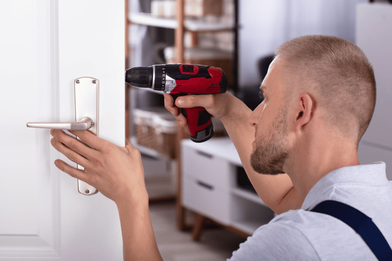 Locksmith using screwdriver to fix the lock