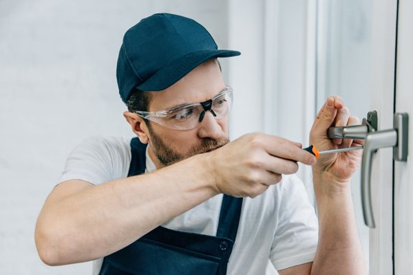 Experienced locksmith fixing broken house lock