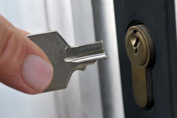 Locksmith extracting broken key from lock