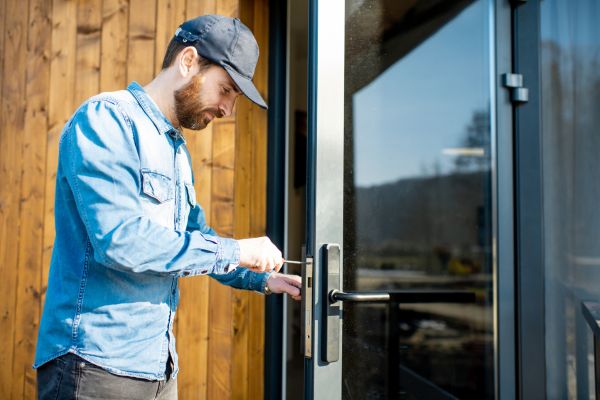 Commercial locksmith working on an office door