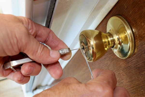 Locksmith technician unlocking a residential door
