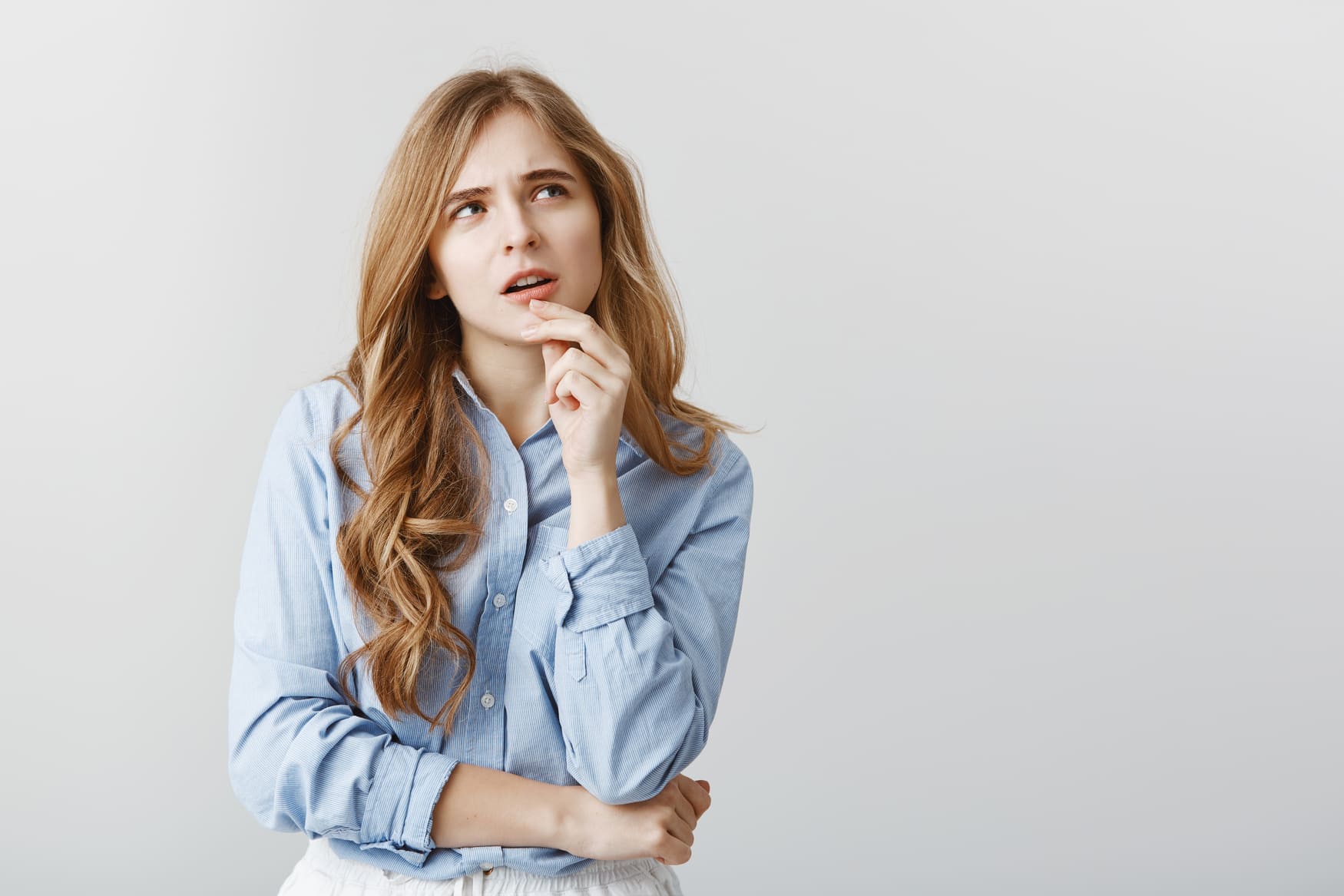 Woman thinking on whether to rekey or change locks