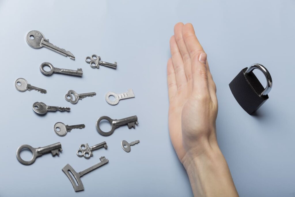 Tons of keys & padlock with a hand in the middle