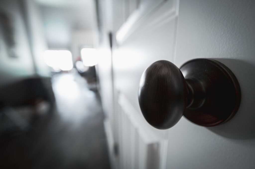 A wooden doorknob and a wooden door