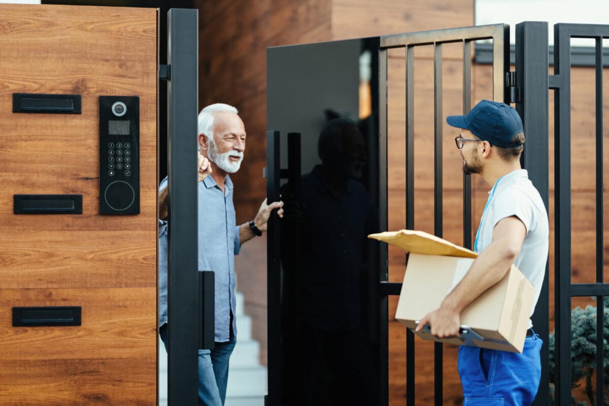 Happy senior man communicating with a locksmith worker