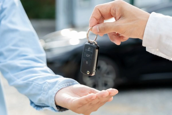 Locksmith handing programmed smart key fob.