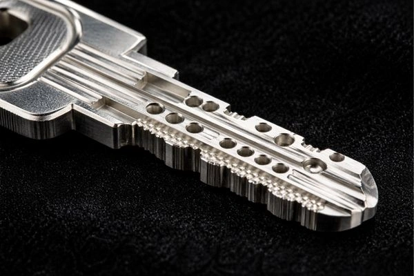 High-security dimple key with complex cuts that requires a certified locksmith to copy